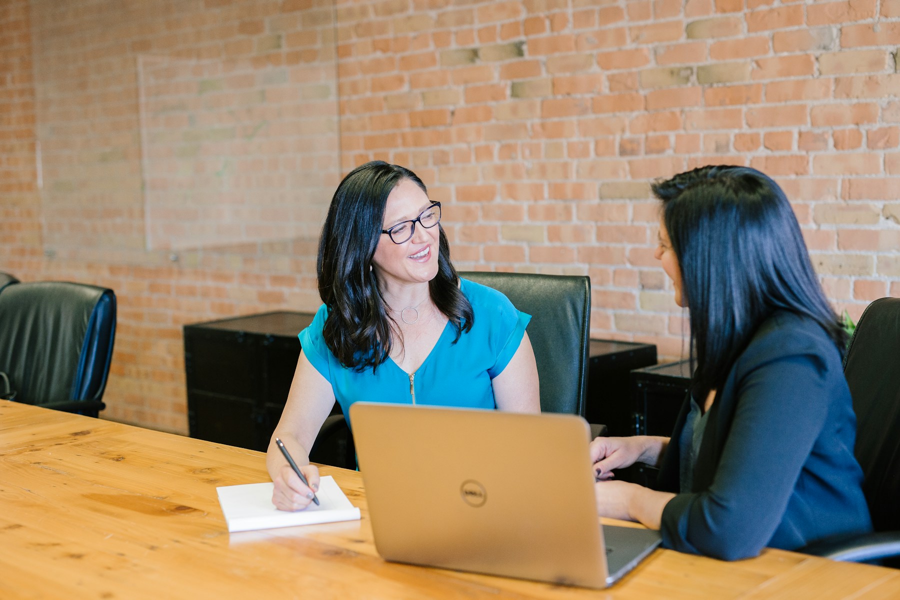 Small business team reviewing appointment scheduling software on a laptop