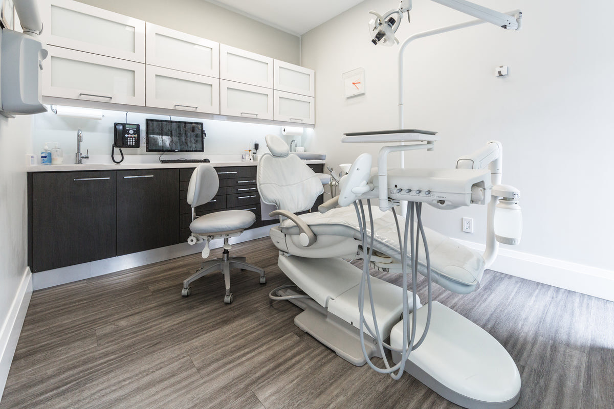 An empty examination chair in a quiet Indian clinic room