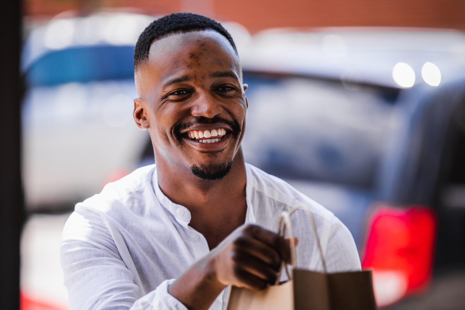 Food delivery riders collecting packed orders at the counter of a cloud kitchen