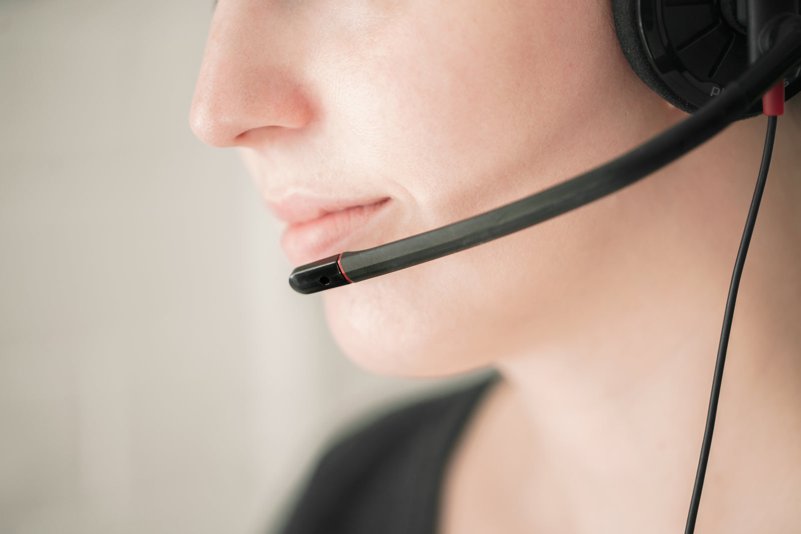 Smiling service representative helping a customer at a bright retail service counter