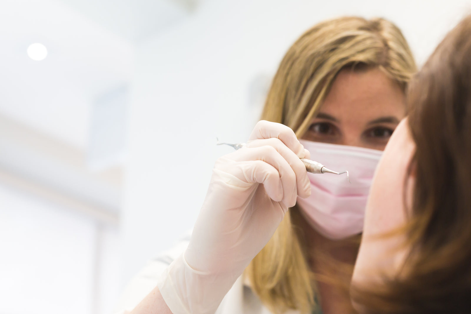 A patient at a dental reception desk confirming an appointment