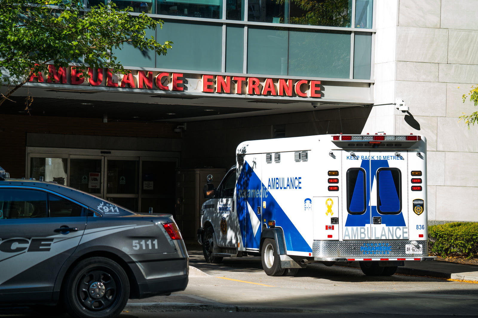 Ambulance parked outside the entrance of a hospital emergency department in the United States
