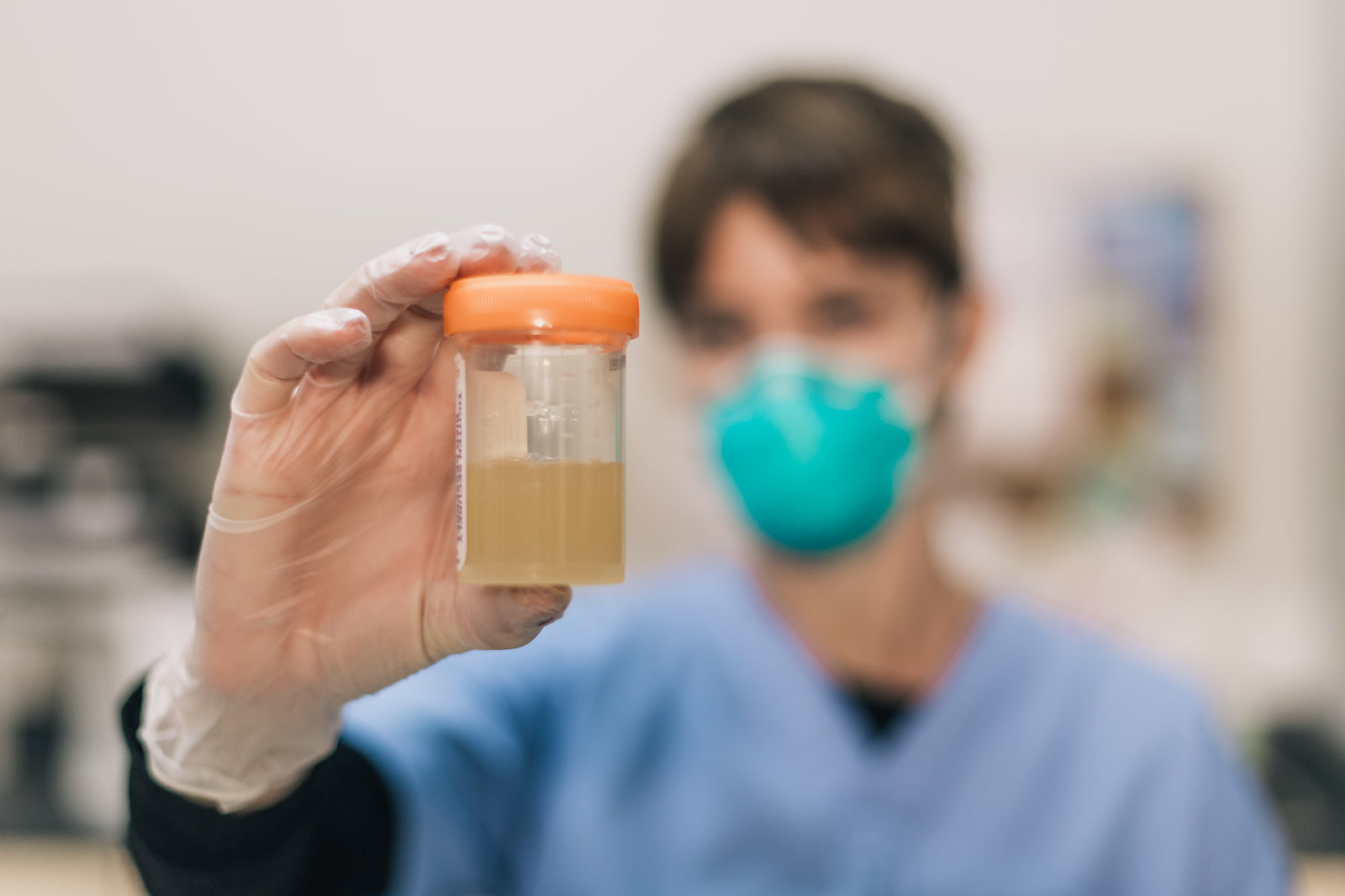 Medical laboratory technician handling blood sample tubes during testing