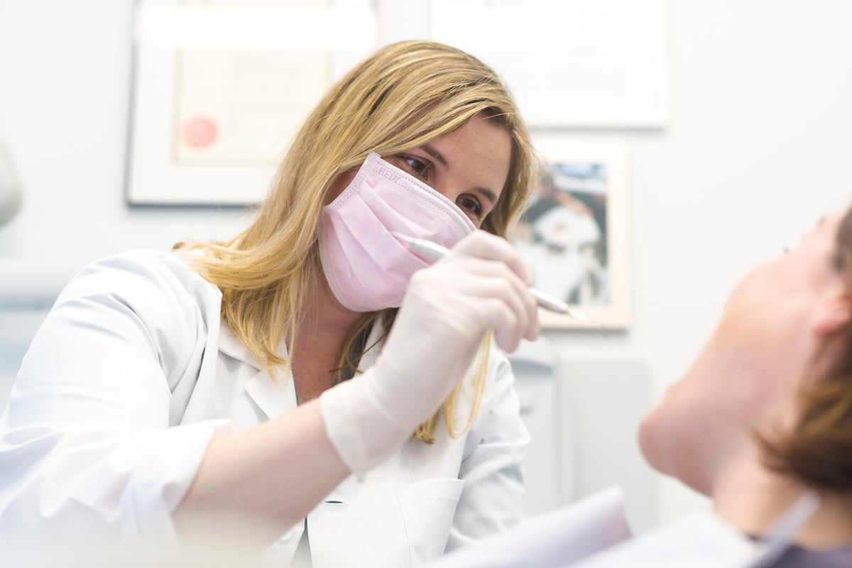 A dentist talking with a patient in the chair