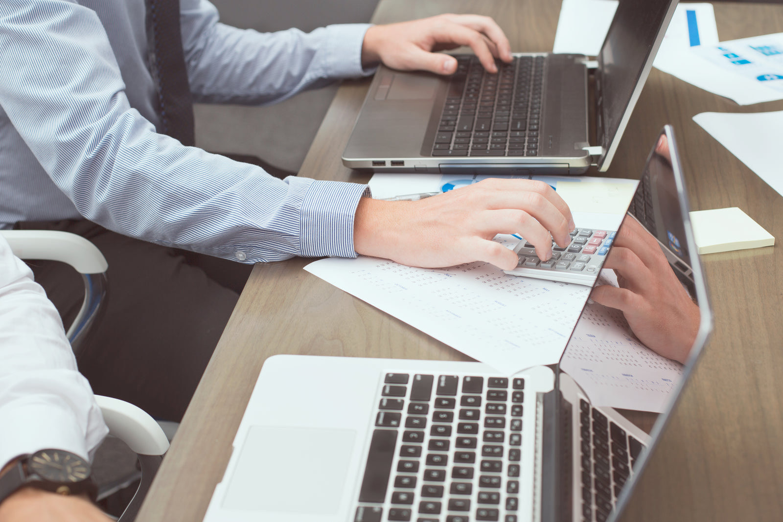 Calculator, cash and planning notes spread on a desk during budget planning