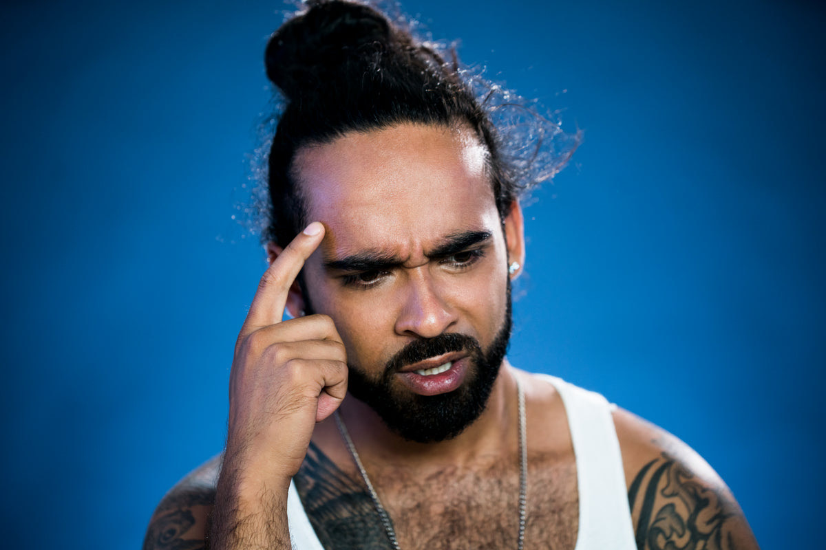 A puzzled small business owner looking at a queue of waiting customers near the counter