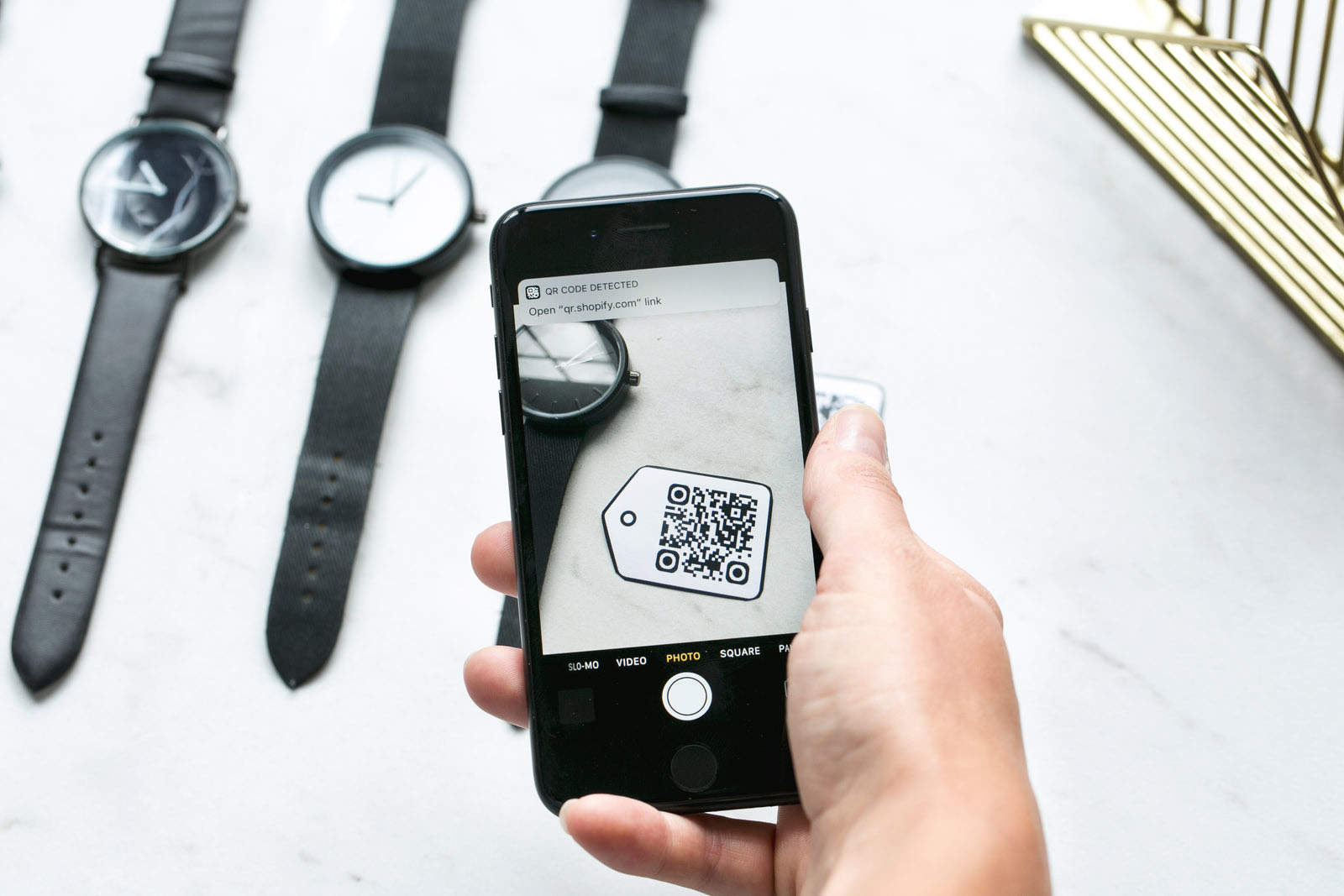 Diners at a restaurant table scanning a QR code menu with a phone