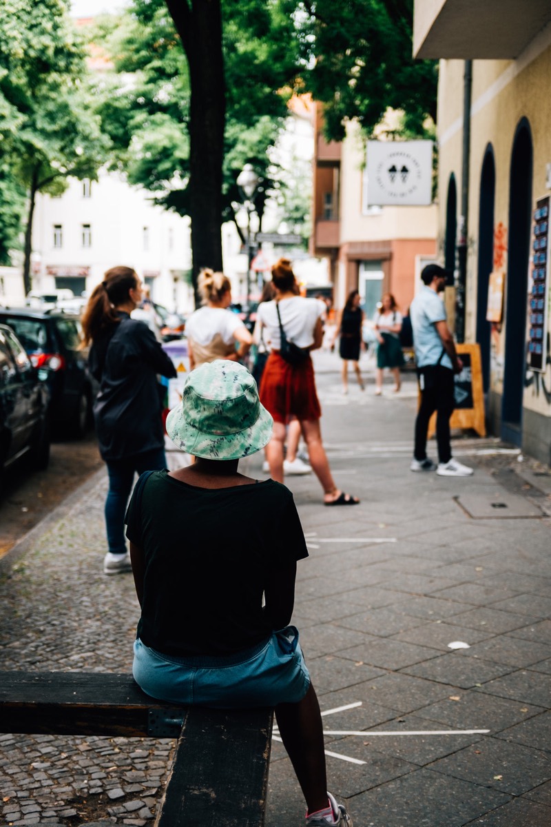 Shoppers standing in a long checkout line holding baskets and waiting to pay