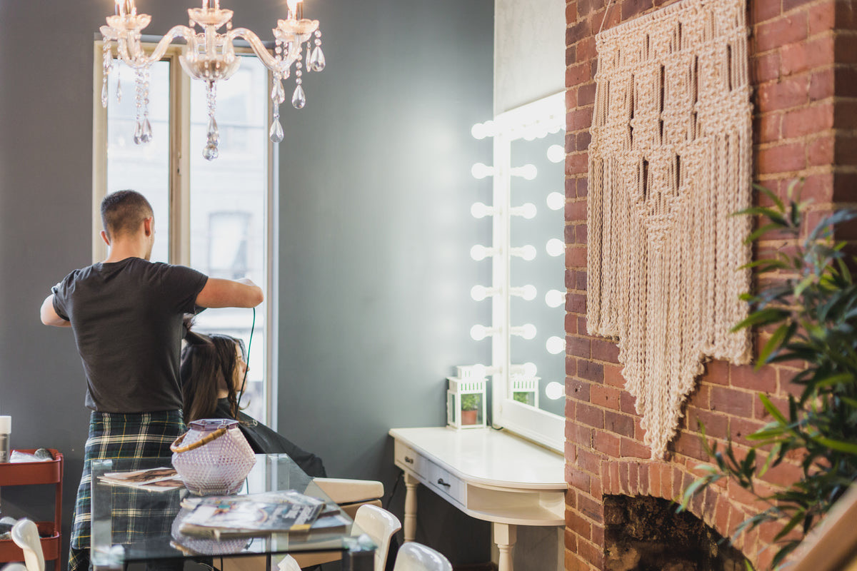Busy hair salon full of clients and stylists working during peak hours