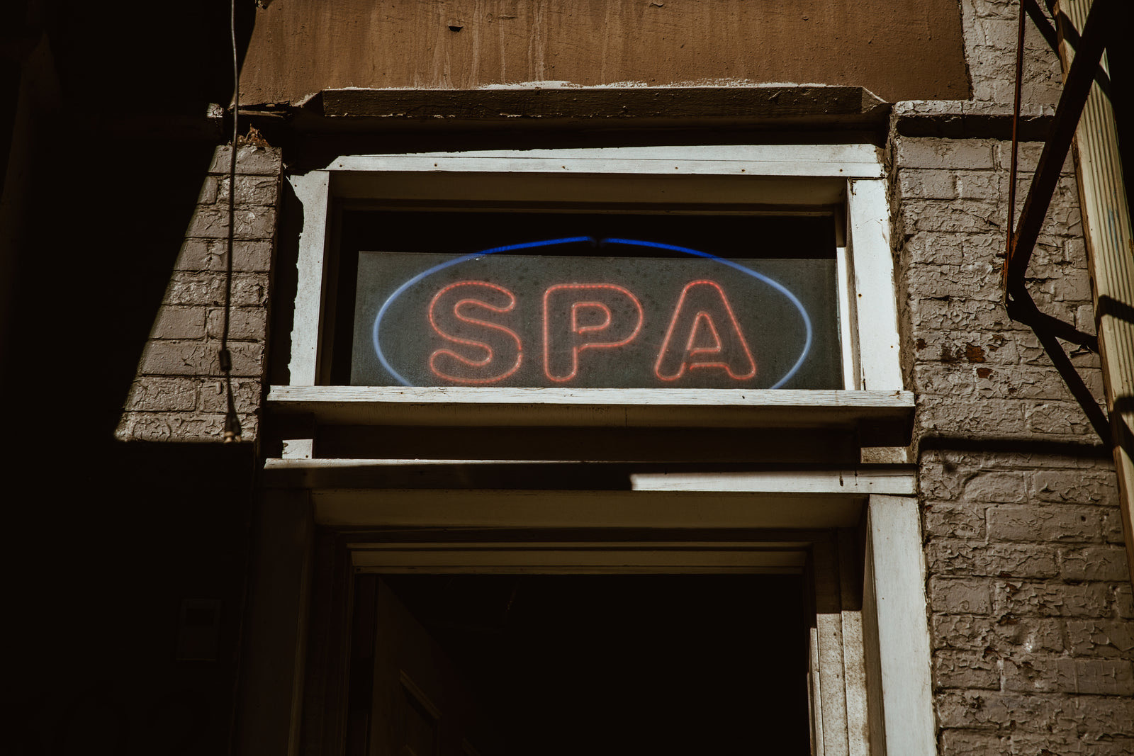 The reception area of a day spa with a host greeting walk-in guests