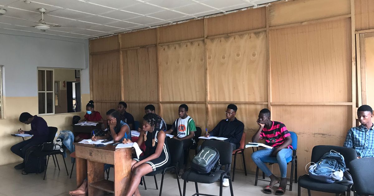 Coaching center classroom with students using a booking app to reserve study sessions